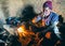 Elderly native enjoying tea in traditional mud house with clay stove in Garhwal, Himalayas. Rich cultural heritage captured