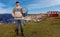 An elderly Norwegian stands on the shore of the North Sea and shows his fishing equipment.