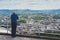 Elderly old man looking on observation deck in trip holiday in Bilbao, pensioner enjoying view on seascape on mountain and ocean