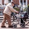 Elderly Older Man Using A Walking Frame To Assist Walking