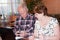 Elderly pair at the table with a notebook