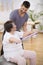 Elderly pensioner exercising with resistance bands with her professional physiotherapist