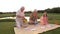 Elderly people and child on picnic.