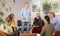 Elderly people communicating in language club with female tutor