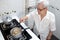 Elderly people cooking vegetables soup or stock in a saucepan and heating the ingredients,healthy food,good cook,asian senior
