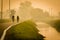 Elderly people in countryside bike road near little brook in fog