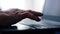 Elderly people and modern computers theme. Close-up of a wrinkled elderly man`s hand on a laptop keyboard. Senior citizen learns t