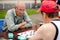Elderly people play checkers in the park. amateur competitions