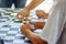 Elderly people playing domino. Image of dominos on a wooden table in the middle of a game