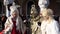 Elderly people wearing Venetian costumes holding hands during Venice Carnival