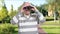 Elderly person with binoculars outdoors.