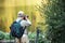 An elderly photographer takes pictures of a landscape in a city park, Tokyo, Japan. Copy space for text.