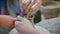 An elderly potter teaches children to make pots of clay. Fair in the open air, close-up