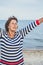 Elderly pretty woman enjoys relaxing by the sea