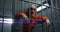 Elderly prisoner in orange uniform holds hands on metal bars in jail