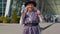 Elderly retired woman tourist near airport terminal celebrating success, winning and goal achievemen