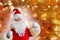 Elderly santa claus in a suit, with a white beard congratulates children and adults, shows with his hands, the concept of