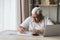 Elderly senior 80s man in glasses doing paperwork at home