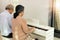 Elderly senior couple play Piano music together. Group of Two Asian smart mature Person retire and get pension fund. Grandparent