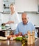 Elderly senior with mature wife doing home chores