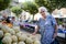 Elderly senior woman buying fresh vegetables and fruits in farmer`s market during summer day in provence france