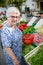 Elderly senior woman buying fresh vegetables and fruits in farmer`s market during summer day in provence france