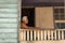 An elderly shirtless Belizean man resting on the balcony