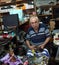 Elderly shoemaker works in his workshop