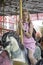 Elderly spending time at theme park on weekend, senior woman hanging out and having fun at amusement park. Grandma enjoying riding