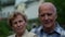 Elderly spouses are smiling looking to each other, portrait of old man and woman