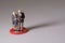 Elderly standing on a red circle. Miniature people figure photography