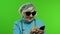 Elderly stylish caucasian grandmother woman using social media app on smartphone