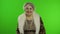 Elderly stylish grandmother. Caucasian woman posing on chroma key background