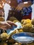 Elderly Thai female vendor ride motorcycle selling durians and fruits and vegetables to tourists at roadside. Street Merchant cut