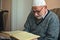 Elderly Turkish muslim male reciting the holy book of Islam, Qur`an in Ramadan