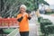 Elderly white haired Asian woman talking Video call while exercising in the park in the morning