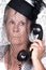 Elderly widow talking on old phone