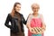 Elderly woman with an apron holding a pie and a young woman standing next to her