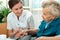 Elderly woman is assisted by nurse at home