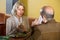 Elderly woman bored in a restaurant while her man talking on the