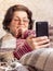 Elderly woman browses news on a smartphone. Communicate with your phone during quarantine