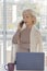 Elderly woman businessman talking on the phone in the office.  Concept: work for retirees, old workers, permanent leader