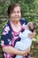 Elderly woman carrying a baby in arms, great grandmother portrait with her great grandchild