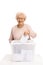 Elderly woman casting a vote into a ballot box