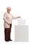 Elderly woman casting a vote in a ballot box and looking at the camera