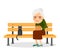 Elderly woman and cat sitting on park bench