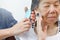 Elderly woman combing hair by caregiver