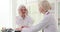 An elderly woman complains to the doctor on a headache