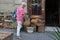 An elderly woman considers the flowers exhibited on the street near the flower shop in Barcelona