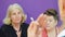 Elderly woman is consulting with beautician about skin care. Cosmetologist`s group consultation